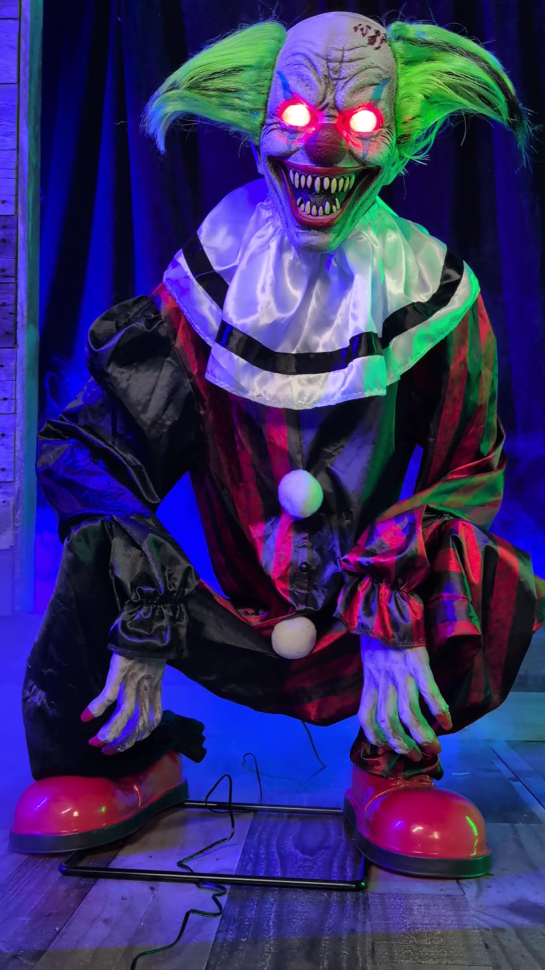 Bring twisted terror to your scene with the Crouching Clown Red Animatronic Decoration, a chilling addition to your spooky Halloween décor.